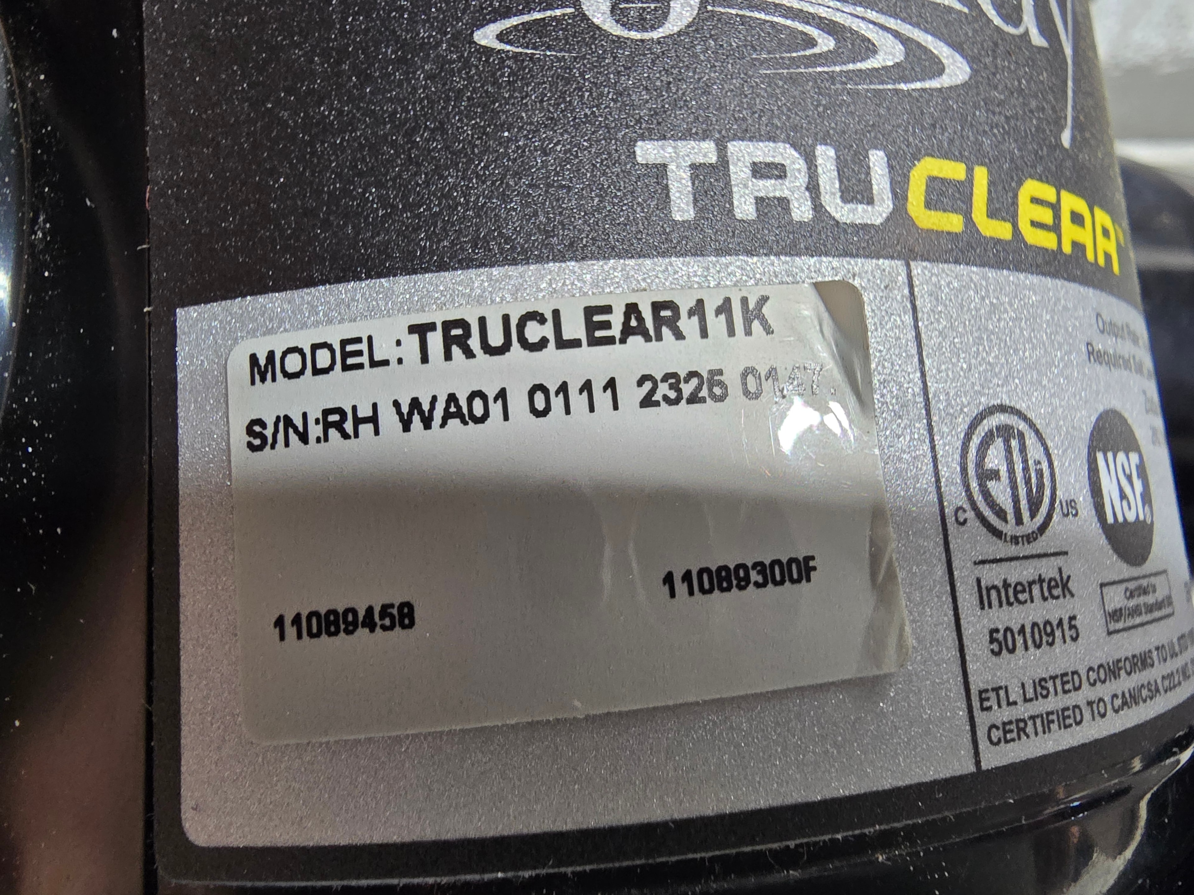 Jandy TruClear 11K label close-up — model TRUCLEAR11K, serial number, Intertek 5010915, NSF certified