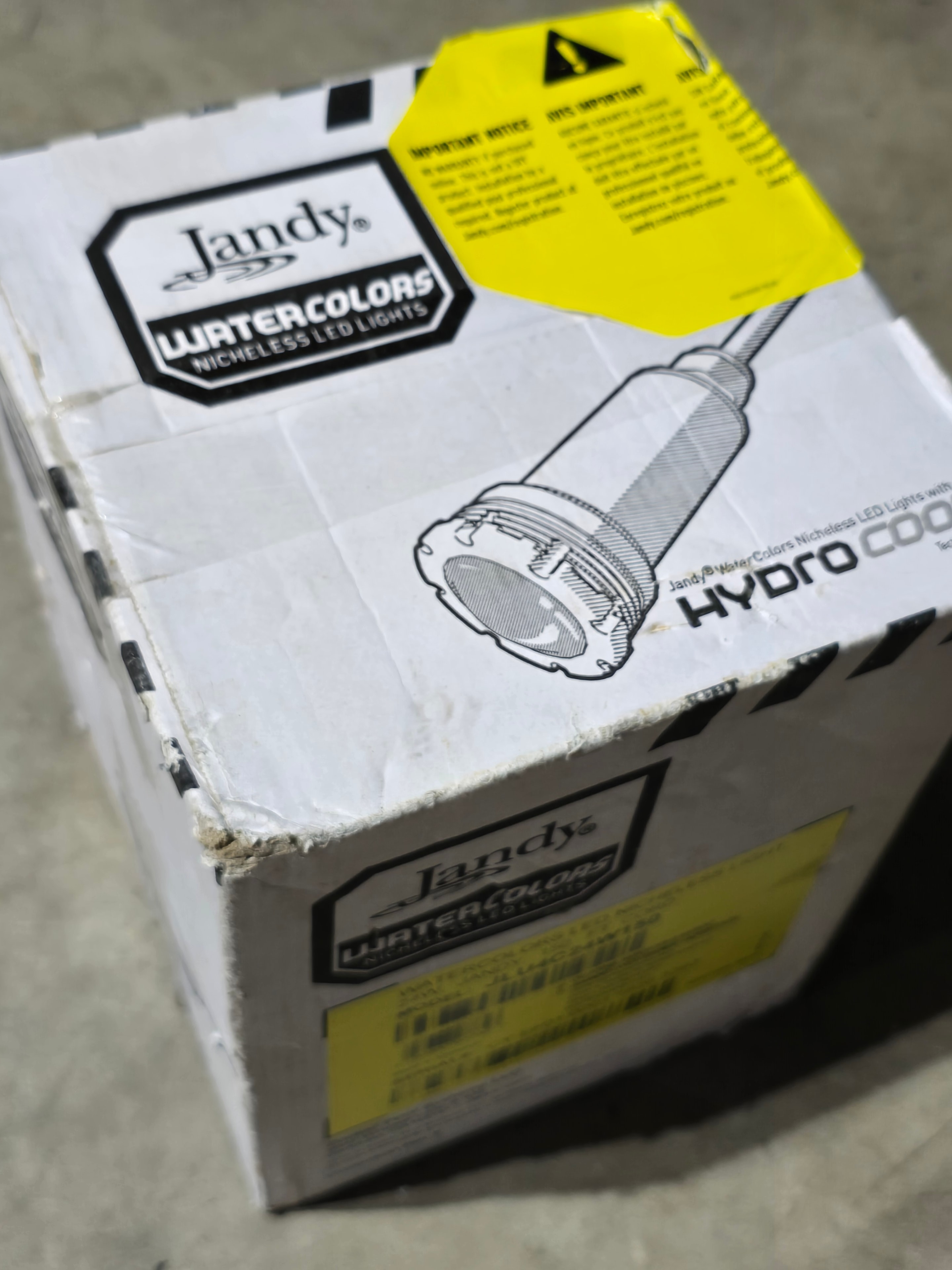 Jandy WaterColors LED light box open — contents and accessories inside packaging